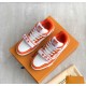 Display View of Orange L Trainer Monogram Denim Low Top Trainers in orange and white Angle showing both orange and white L trainers positioned on a branded box