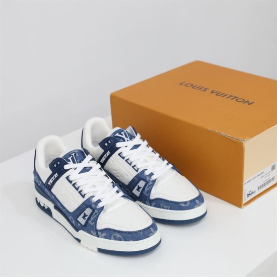 Front Three-Quarter View - L Trainer Monogram Denim Blue And White Low Top Trainers Front three-quarter view of L Trainer Monogram Denim Blue And White Low Top Trainers on white surface