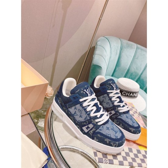 L Monogram Blue Denim Low Top Trainer Sneakers pair displayed on table