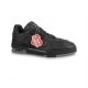 Studio profile shot of L black monogram leather trainer low top shoes in black and red