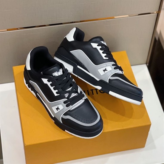 Angled pair arrangement of L trainer low top leather sneakers in black and grey
