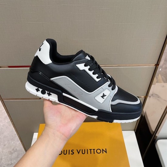 Handheld side view of the L trainer low top leather sneakers in black, grey, and white