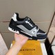 Handheld side view of the L trainer low top leather sneakers in black, grey, and white