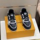 Top-down view of the black laces and tongue on the L sneakers in black and grey
