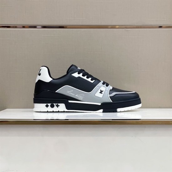 Side profile of L trainer low top leather sneakers showcasing the signature script detail in black and grey