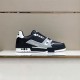 Side profile of L trainer low top leather sneakers showcasing the signature script detail in black and grey