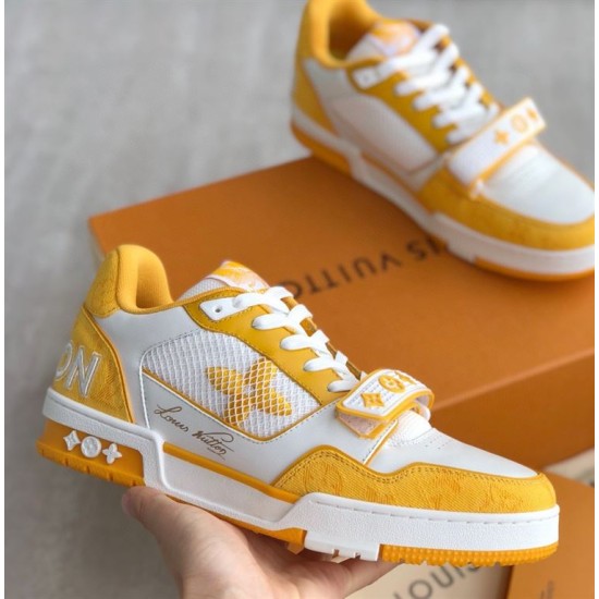 L Trainer Sneaker Yellow White Strap Low Top held view Handheld angle of yellow and white strapped trainer