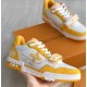L Trainer Sneaker Yellow White Strap Low Top held view Handheld angle of yellow and white strapped trainer