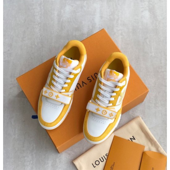 L Trainer Sneaker Yellow White Strap Low Top overhead view Top down view of yellow and white trainers on a box