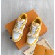 L Trainer Sneaker Yellow White Strap Low Top overhead view Top down view of yellow and white trainers on a box