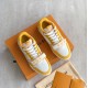 L Trainer Sneaker Yellow White Strap Low Top top angle Top down pair view on packaging surface in yellow and white