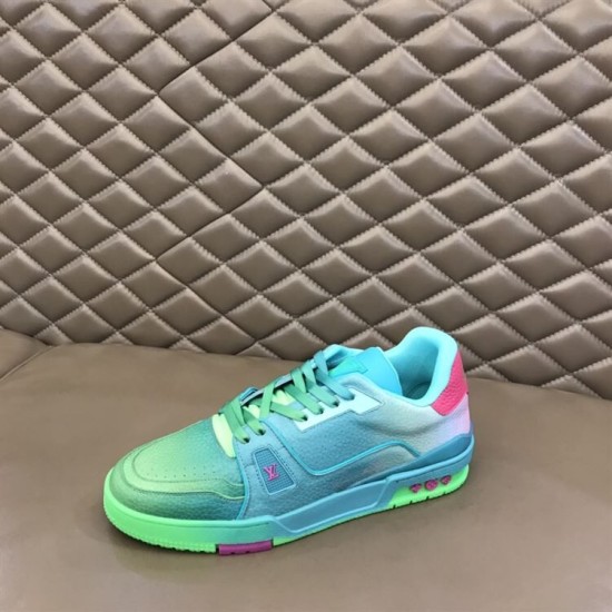 L Trainer Low Top Sneakers In Green Grained Leather - Side Rest View in green and pink Side profile view resting on surface showing L trainer low top sneakers in green grained leather in green and pink
