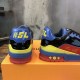 Back Heel View of L Colourblock Patent Canvas Trainers in multi-colour and red Rear heel view displaying the contrasting blue collar and yellow numbering on the L trainers in multi-colour and red