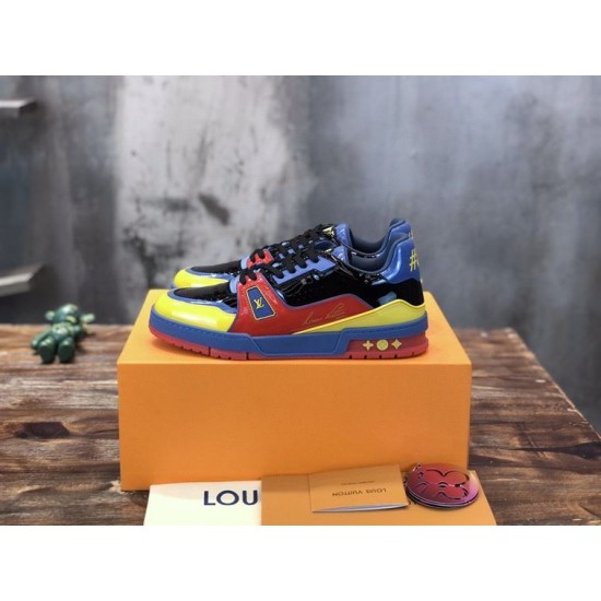 Angled View of L Colourblock Patent Canvas Trainers in multi-colour and red Angled side view of the L multi-colour trainers resting on a branded packaging box in multi-colour and red