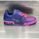 Side profile of L low top trainer leather sneakers highlighting signature side signature and trim in pink and blue
