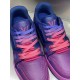 Close up view of laces and tongue on L low top trainer leather sneakers in pink and blue