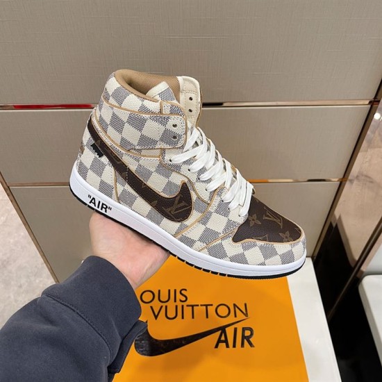 Handheld lateral view of L high top trainer in white and brown above branded box