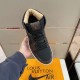 Overhead view of the brown and black L trainers lacing and tongue Top-down view of the brown and black L trainers showing laces and tongue branding