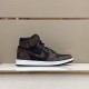 Side profile of the brown and black L high top trainers Side profile of the brown and black L trainers on a display surface