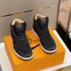 Pair view of the brown and black L high top trainers Pair of brown and black L high top trainers positioned on top of an orange box