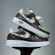 Stacked pair of Nike Air Force 1 Low Patterned Brown Trainers showing lateral sides