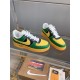 Nike Air Force 1 Low-Top Yellow And Green Trainers Angled View Top-angled view of yellow and green Nike Air Force 1 trainers displayed on glass