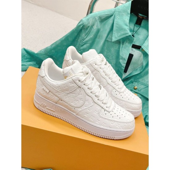 Nike Air Force 1 Low Embossed White Trainers pair on shoe box