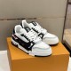 L White And Black Trainers Angled Pair Angled pair view of L white and black trainers resting on an orange box
