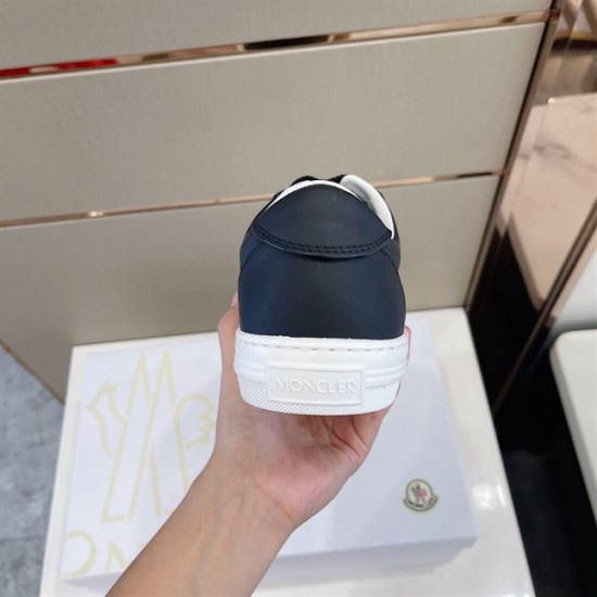 Moncler Dark Blue Trainer Heel View in dark blue and white Rear heel view of Moncler dark blue leather trainer featuring embossed heel logo in dark blue and white