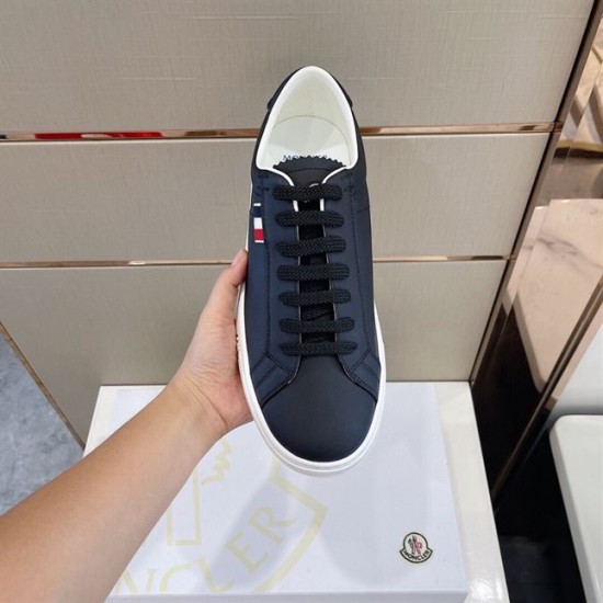 Moncler Dark Blue Leather Trainer In Hand Top Angle in dark blue and white Close-up top view of single Moncler dark blue leather trainer held in hand in dark blue and white