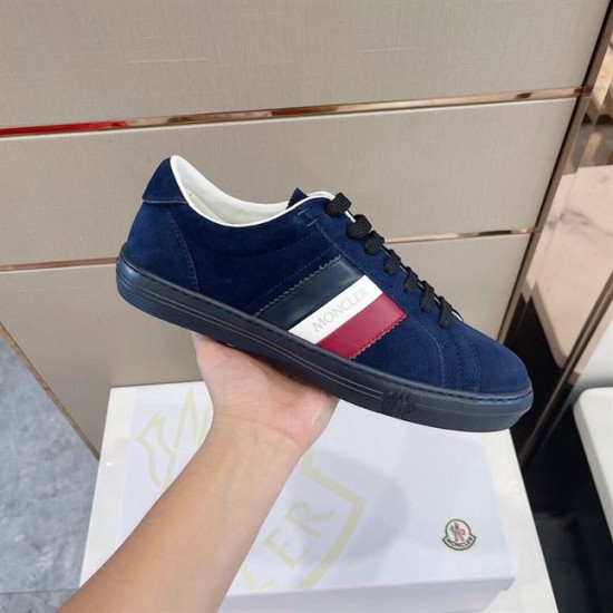 Moncler New Monaco Suede Trainers Navy Low Top Handheld Side View Side view of Moncler New Monaco Suede Trainers Navy Low Top held against box