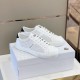 Pair of white Moncler perforated leather trainers on shoe box