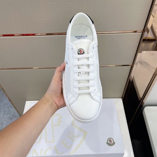Top-down perspective of white Moncler perforated trainer showing tongue logo