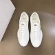 Direct top view of both Moncler Promyx white leather low-top trainers side by side