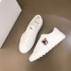 Angled top view of Moncler Promyx white leather trainers showcasing lace placement and opening