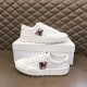 Pair of Moncler Promyx white leather trainers displayed on and beside a shoe box