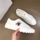 Top-down view of Moncler Promyx white leather trainer held next to the second trainer