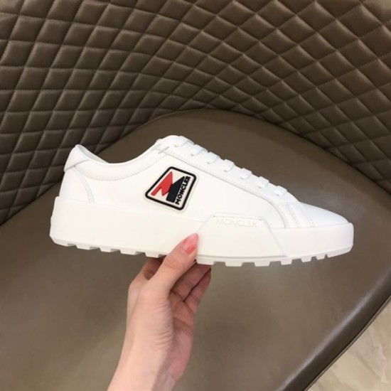Handheld view of Moncler Promyx white leather trainer showing side logo and sole detail