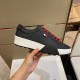 Moncler Promyx Black Trainer Lateral View in black and red Hand holding a Moncler Promyx black leather trainer highlighting the lateral side profile in black and red