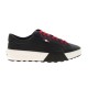 Moncler Promyx Black Leather Trainer Profile in black and red Full side view of Moncler Promyx black leather trainer against a plain background in black and red