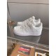 Angle View of L Air Force Embossed Monogram White Trainers Angled pair of L Air Force Embossed Monogram White Trainers on glass shelf