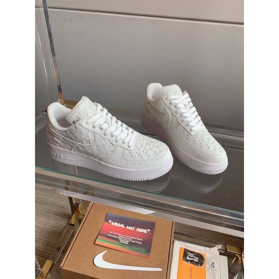 Front Three-Quarter View of L Air Force Embossed Monogram White Trainers Front three-quarter view of L Air Force Embossed Monogram White Trainers