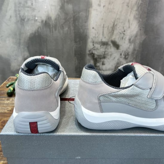 Prada Americas Cup Grey Trainers Rear Heel View in grey and white Rear heel view showing red logo detail on Prada Americas Cup grey leather trainers in grey and white
