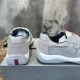 Prada Americas Cup Grey Trainers Rear Heel View in grey and white Rear heel view showing red logo detail on Prada Americas Cup grey leather trainers in grey and white