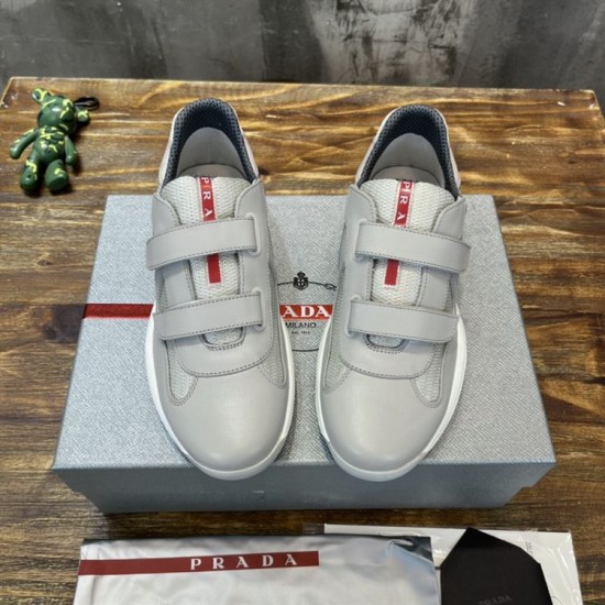 Prada Americas Cup Grey Strap Trainers Top View in grey and white Top view of a pair of Prada Americas Cup grey strap low top trainers sitting on a shoe box in grey and white