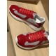 Angled view of Prada red patent leather and grey mesh trainers on display