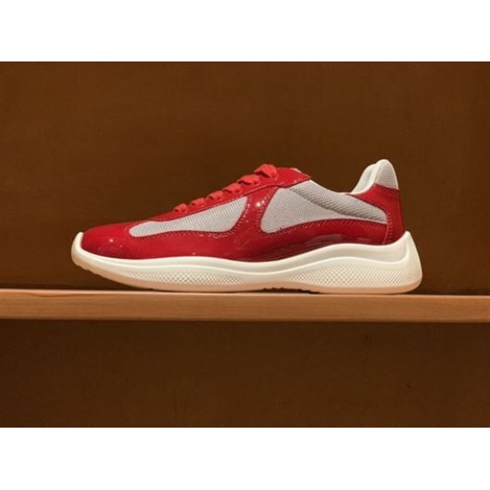Prada America's Cup red patent trainer displayed on a wooden shelf in red and grey