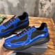 Prada America's Cup Side Mesh Panels in blue and black Side angle view showing black mesh panels and glossy blue patent finish