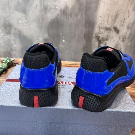 Prada America's Cup Heel Detail in blue and black Rear view showing black soles and red logo heel tabs on blue patent trainers