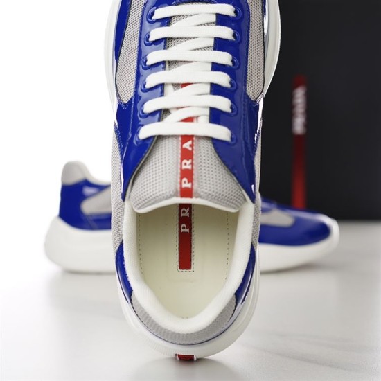Prada America's Cup Trainer Laces and Tongue Detail in blue and grey Close-up front view of the lacing system and red logo tongue on Prada trainer in blue and grey